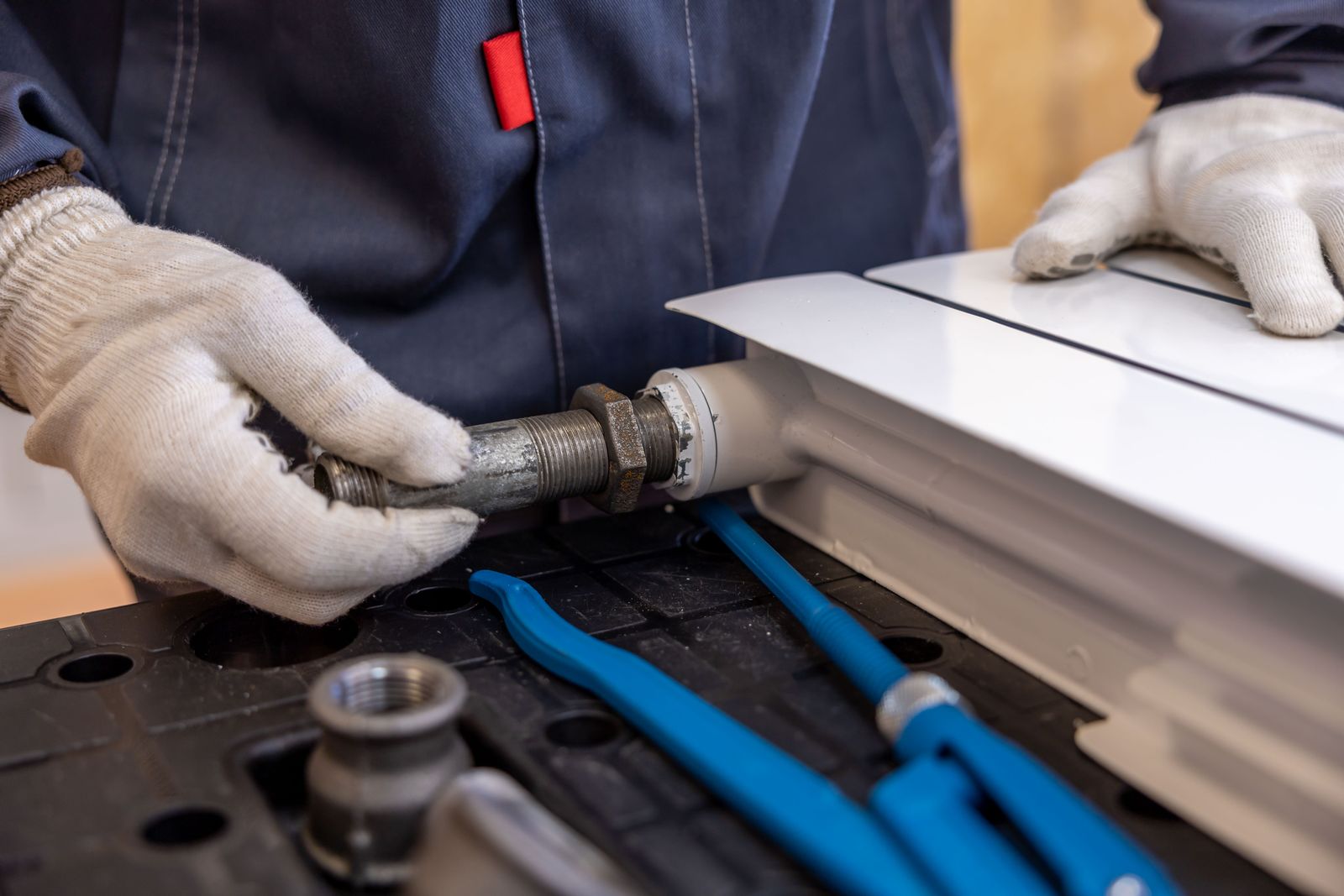 Plumber fitting a pipe with specialist tools