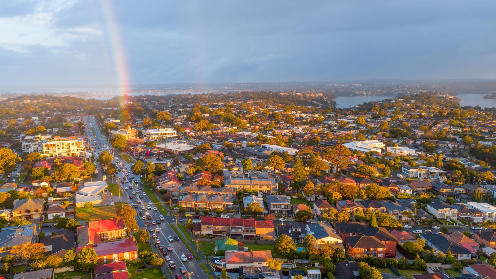 Aerial view of a suburb with a rainbow over the houses