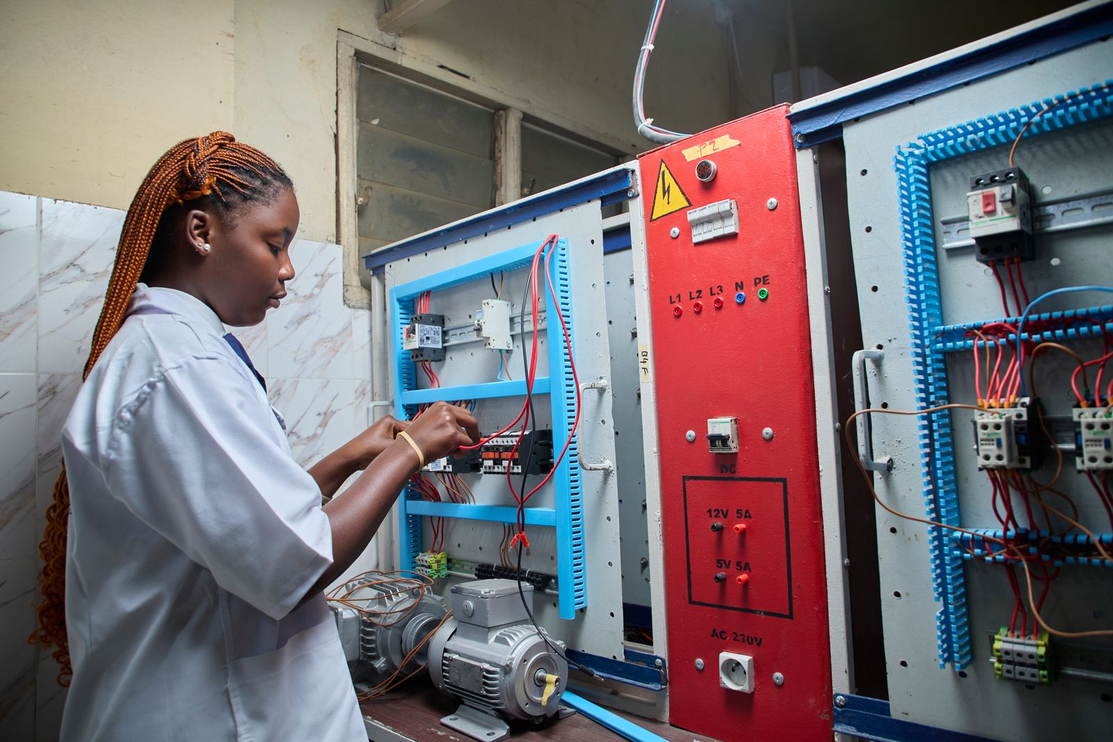 Electrician repairing a control panel