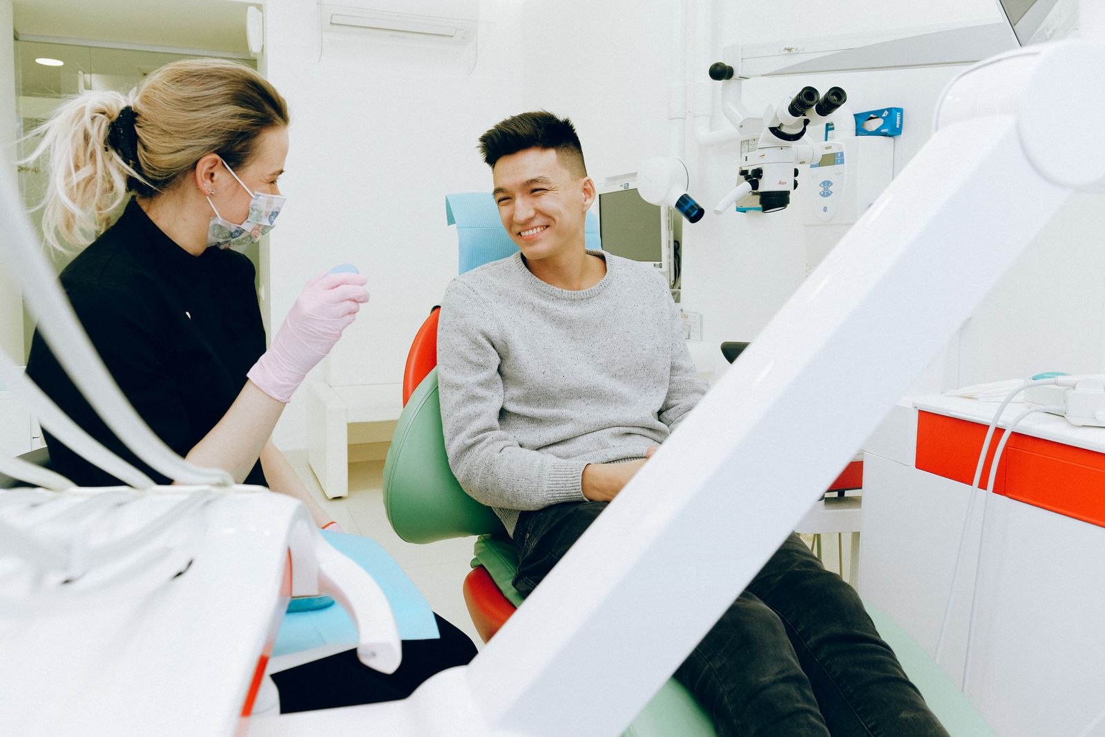 Dentist and patient smiling during a check-up