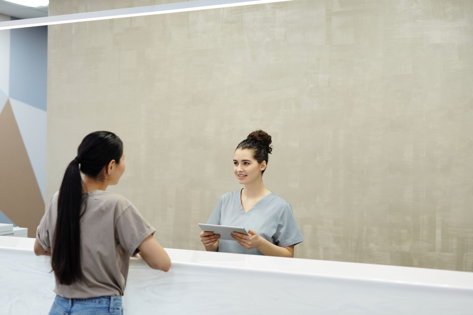 Receptionist smiling while helping a customer